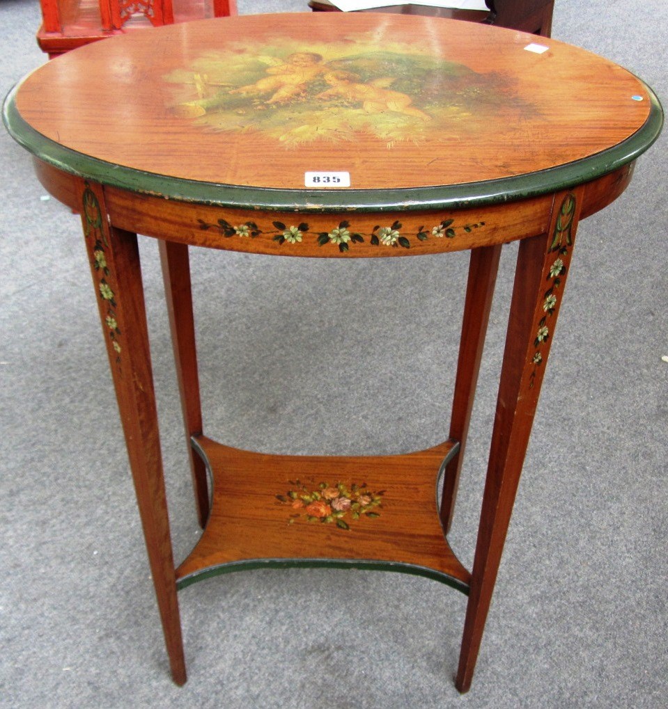 Appraisal: An Edwardian painted satinwood oval two tier occasional table cm