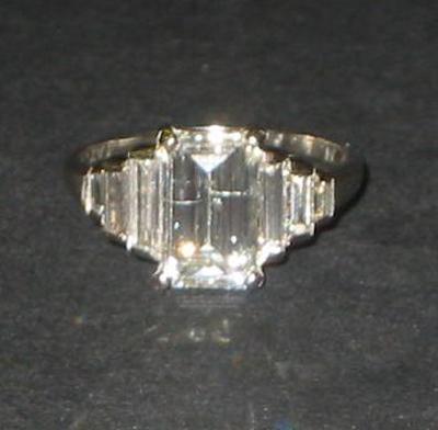 Appraisal: A DIAMOND RING the emerald cut diamond approximately cts claw