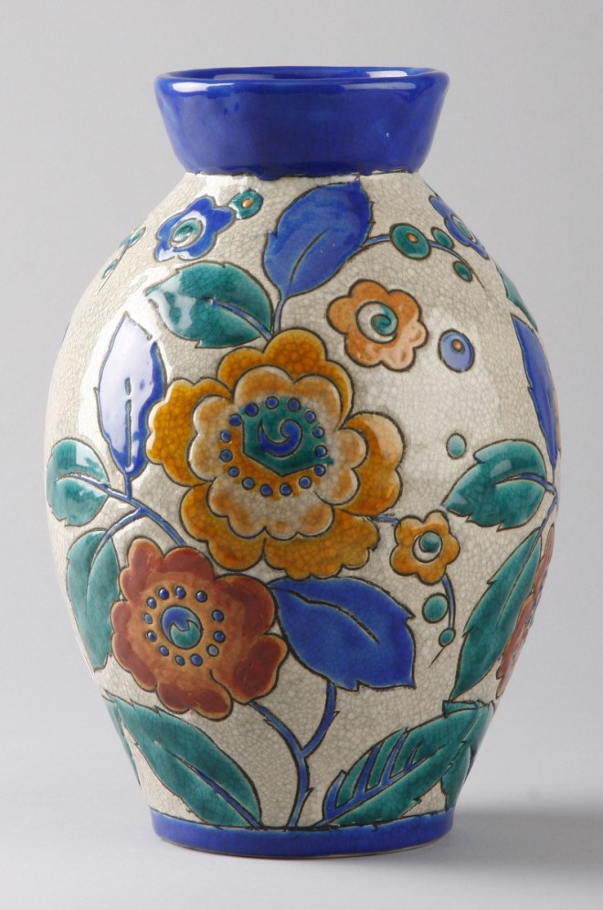 Appraisal: Vase features colorful flowers with cobalt blue neck and border