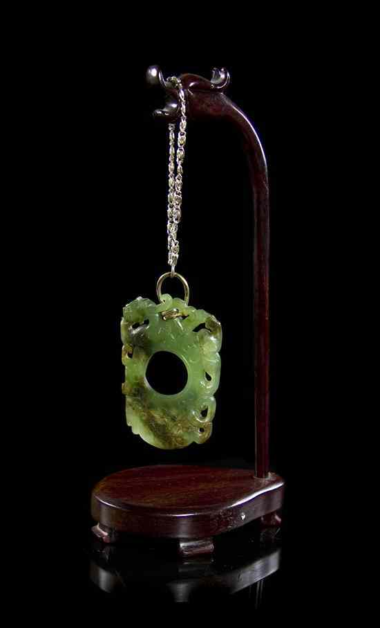 Appraisal: A Green Spinach Jade Pendant having pierce carved beasts on