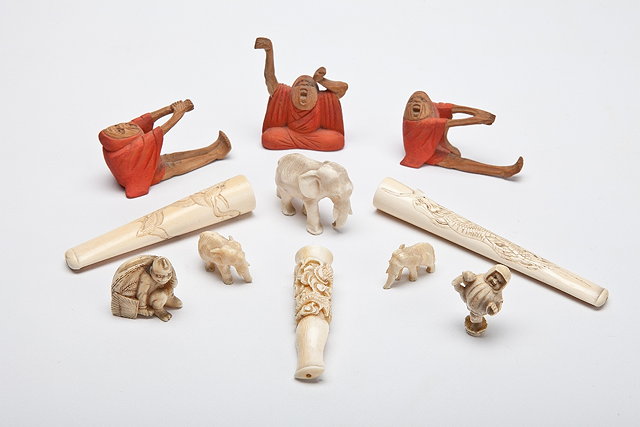 Appraisal: A JAPANESE IVORY NETSUKE Daruma stretching and tearing his clothes