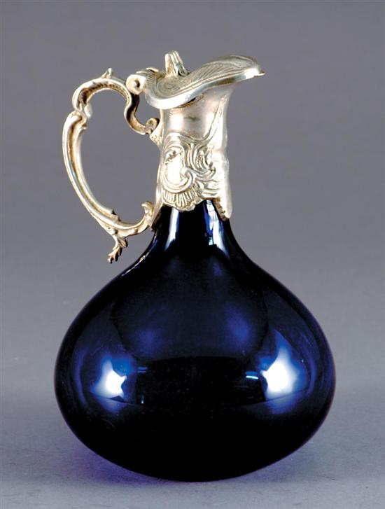 Appraisal: Silver-mounted cobalt glass claret jug hinged ewer-form spout with C-scroll