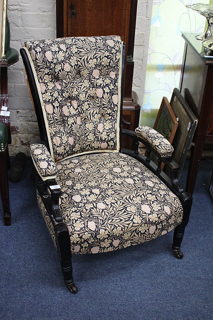 Appraisal: A VICTORIAN EBONISED AESTHETIC ARMCHAIR button upholstered back pad upholstered