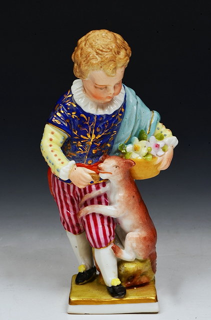 Appraisal: A GERMAN PORCELAIN FIGURE of a young boy wearing patterned