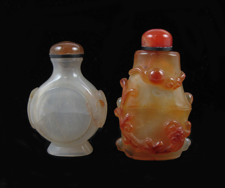 Appraisal: TWO CHINESE CARVED HARDSTONE SNUFF BOTTLES a carnelian bottle with