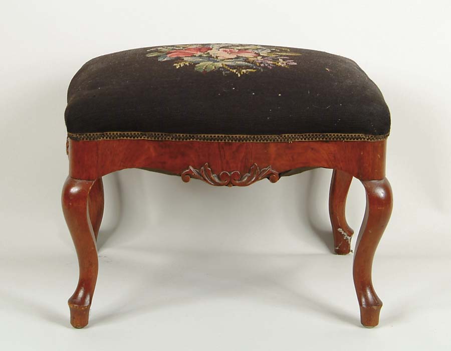 Appraisal: VICTORIAN CARVED WALNUT AND NEEDLEWORK STOOL Serpentine skirt with carved