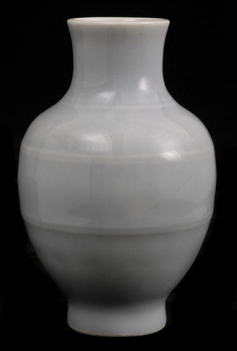 Appraisal: CHINESE PALE CELADON VASE The ringed and footed ovoid bowl