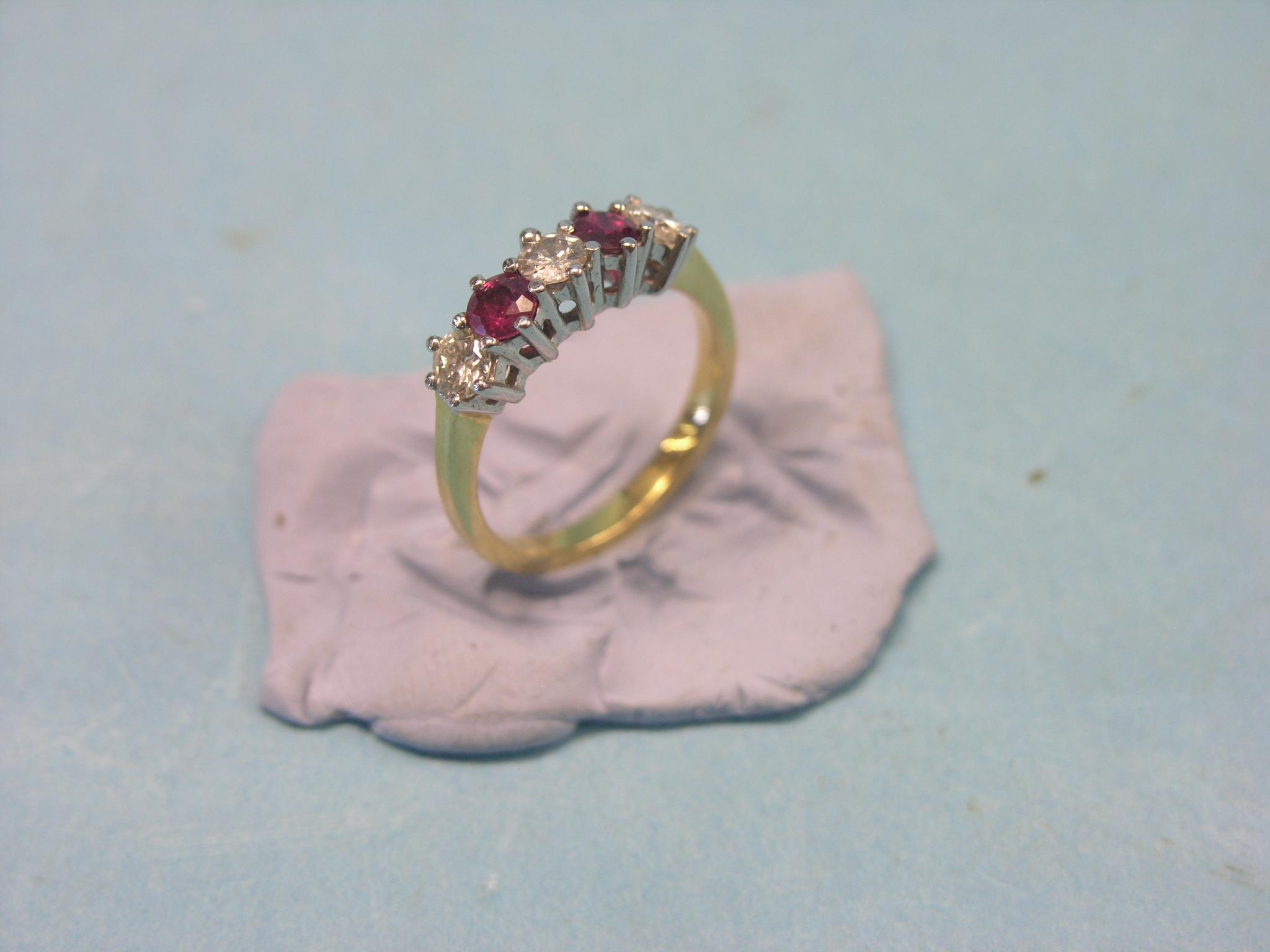 Appraisal: An ct gold half-hoop ring three diamonds two rubies claw