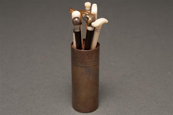 Appraisal: Seven miniature canes with an etched bronze holder marked J