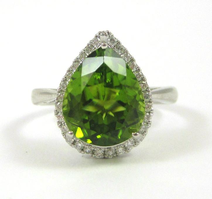 Appraisal: PERIDOT DIAMOND AND FOURTEEN KARAT GOLD RING The white gold