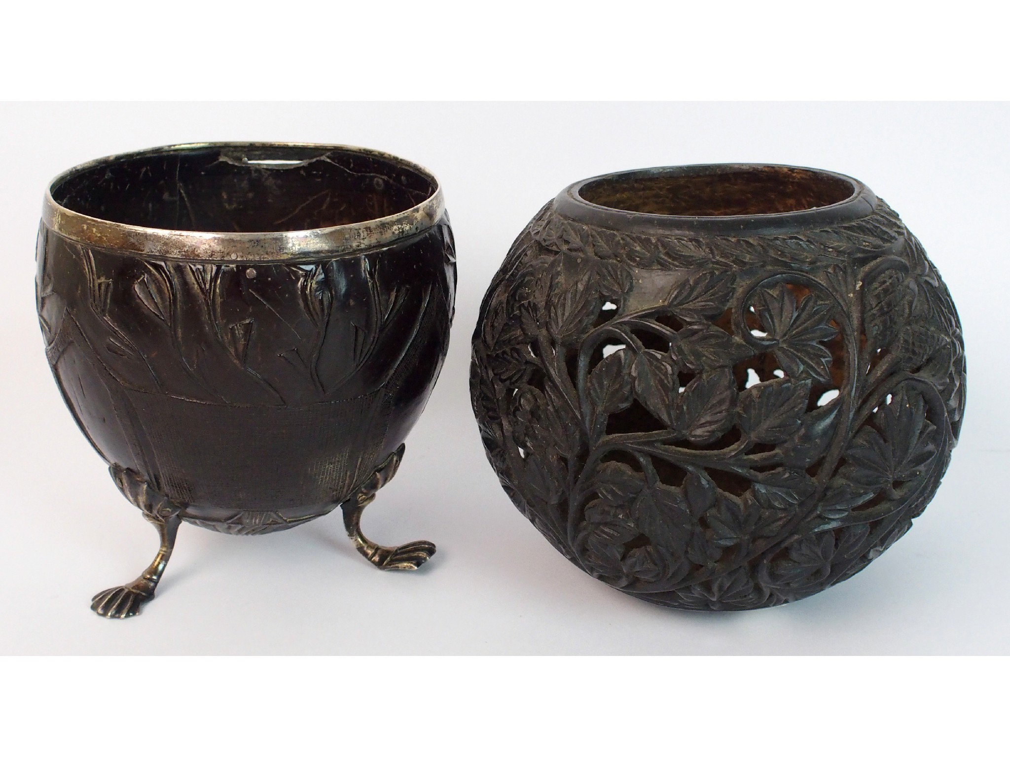 Appraisal: A Georgian white metal mounted carved coconut cupwith plain silver