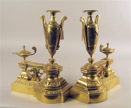 Appraisal: Pair of neoclassical style brass chenets The molded base surmounted