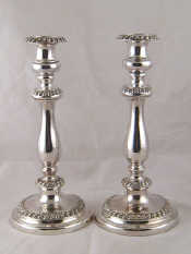 Appraisal: A pair of Old Sheffield plate candlesticks with baluster columns