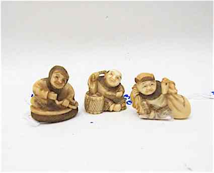 Appraisal: THREE IVORY CARVED NETSUKE FIGURES woman seated men seated- one