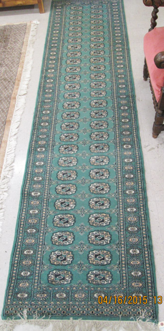 Appraisal: HAND KNOTTED ORIENTAL BOKHARA RUNNER featuring two full-length columns of