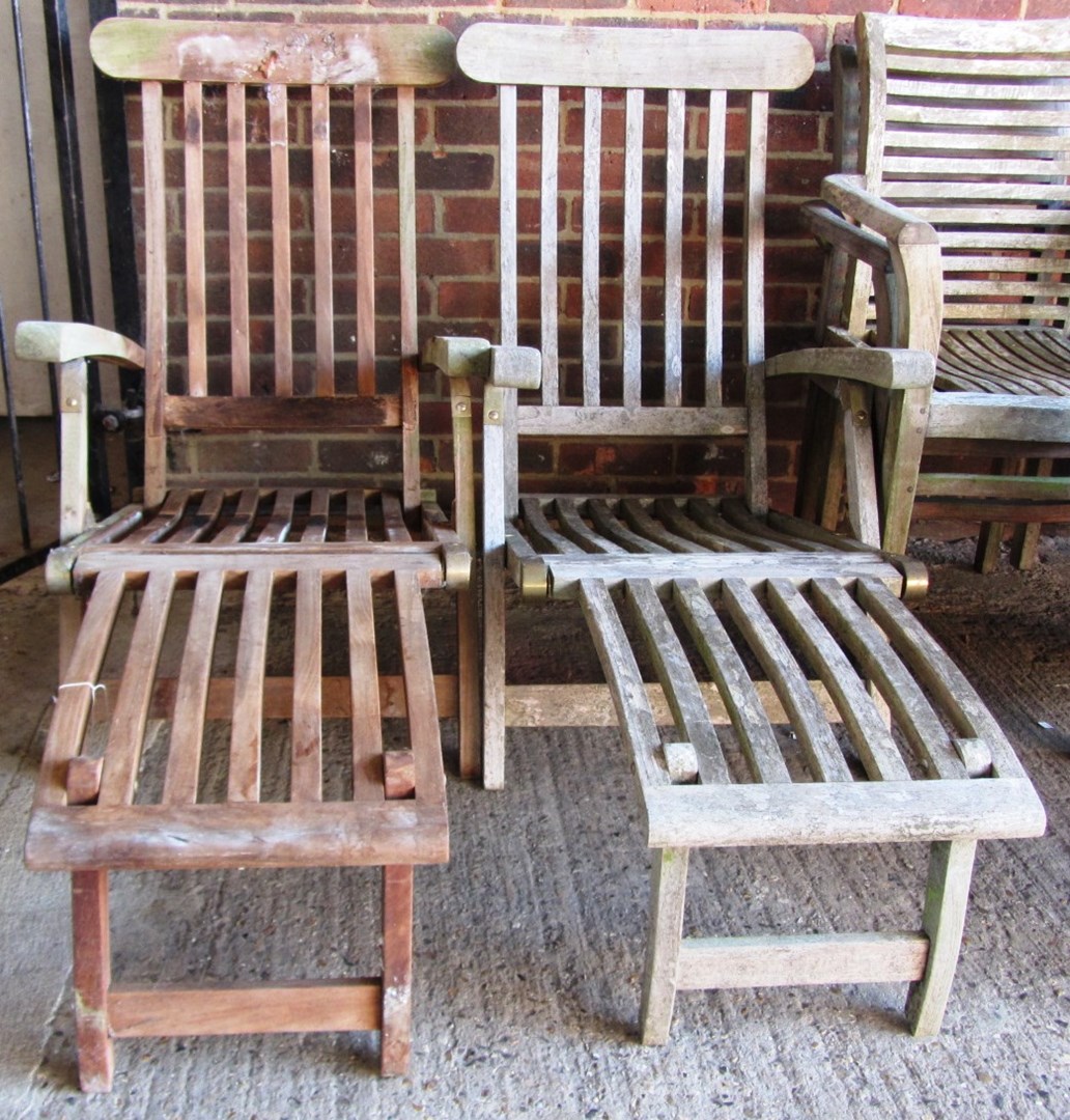 Appraisal: A pair of th century slatted teak steamer chairs