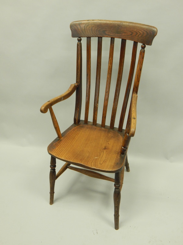 Appraisal: A thC slat back Windsor chair with shaped arms solid