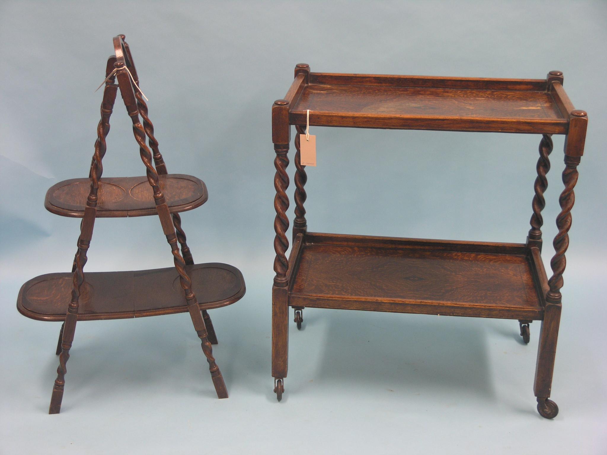 Appraisal: A dark oak folding cake stand and a similar two-tier