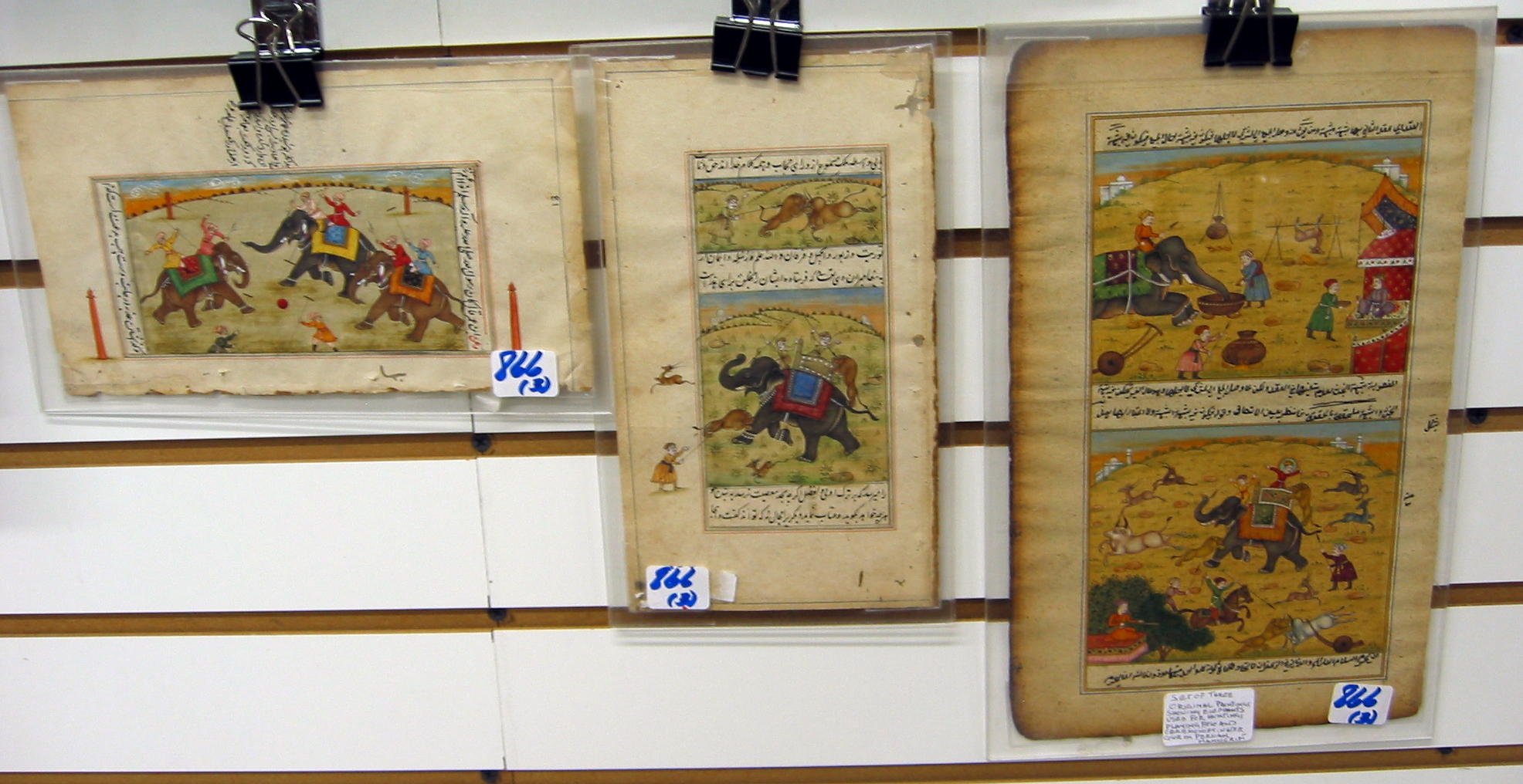 Appraisal: THREE PERSIAN MANUSCRIPT LEAVES with miniature paintings with elephants and