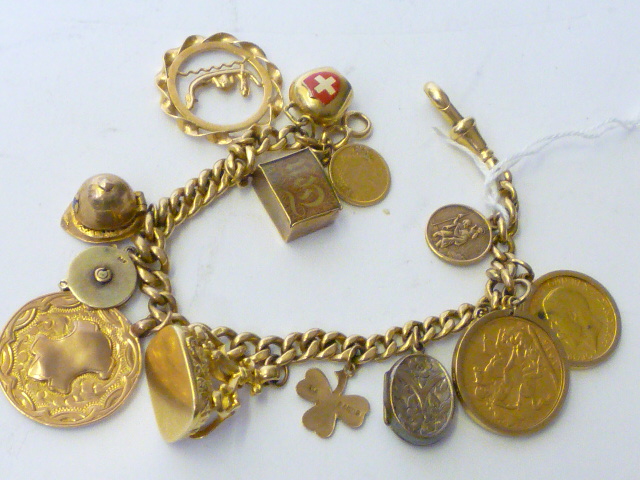 Appraisal: AN CT GOLD CURB LINK CHARM BRACELET hung with a