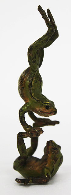 Appraisal: A COLD CAST BRONZE two acrobatic frogs cm wide