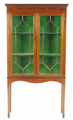 Appraisal: A mahogany display cabinet with marquetry and stringing with a