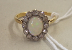 Appraisal: A gold opal and diamond set oval cluster ring mounted