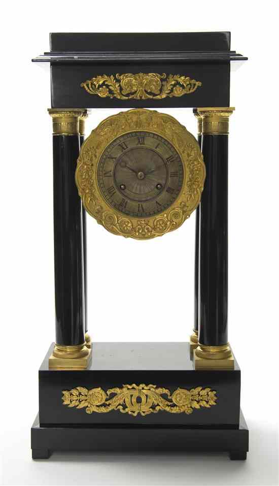 Appraisal: An Empire Style Ebonized and Gilt Metal Mounted Portico Clock