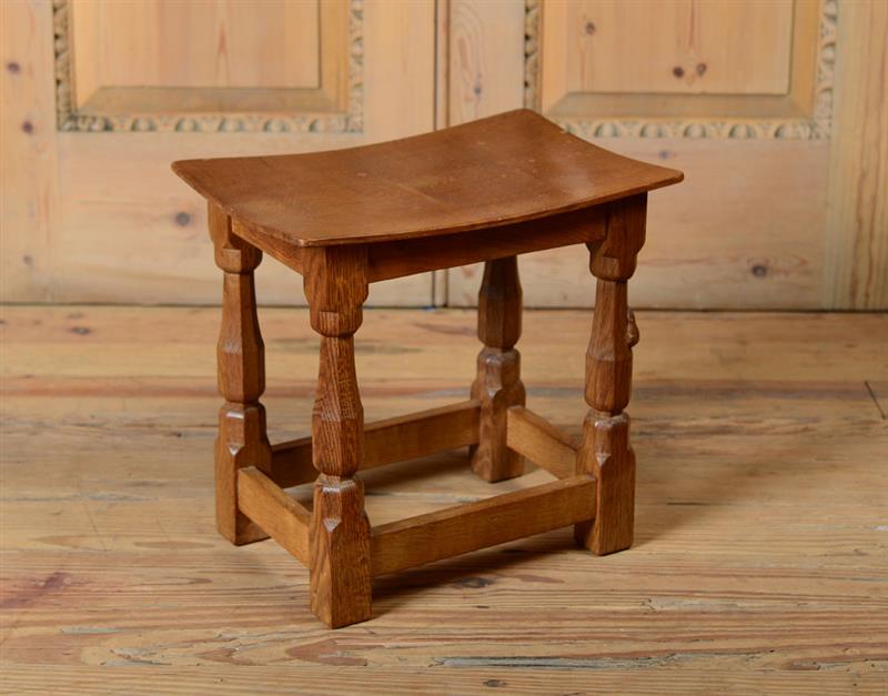 Appraisal: ENGLISH OAK FOOT STOOL DESIGNED BY ROBERT MOUSEMAN THOMPSON With