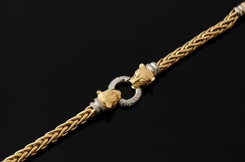 Appraisal: A gold and diamond panther bracelet Having two panther heads