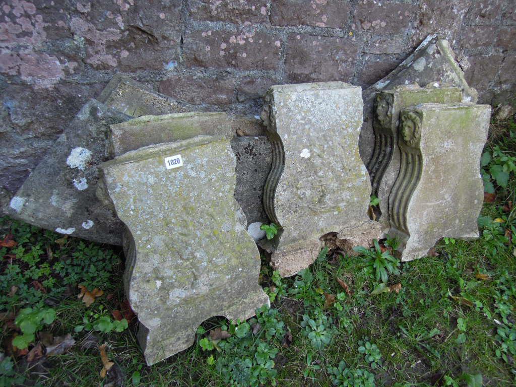 Appraisal: A weathered composition stone garden bench of crescent shaped form