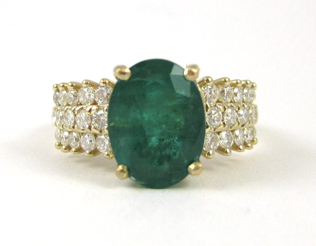 Appraisal: EMERALD DIAMOND AND FOURTEEN KARAT GOLD RING with round-cut diamonds