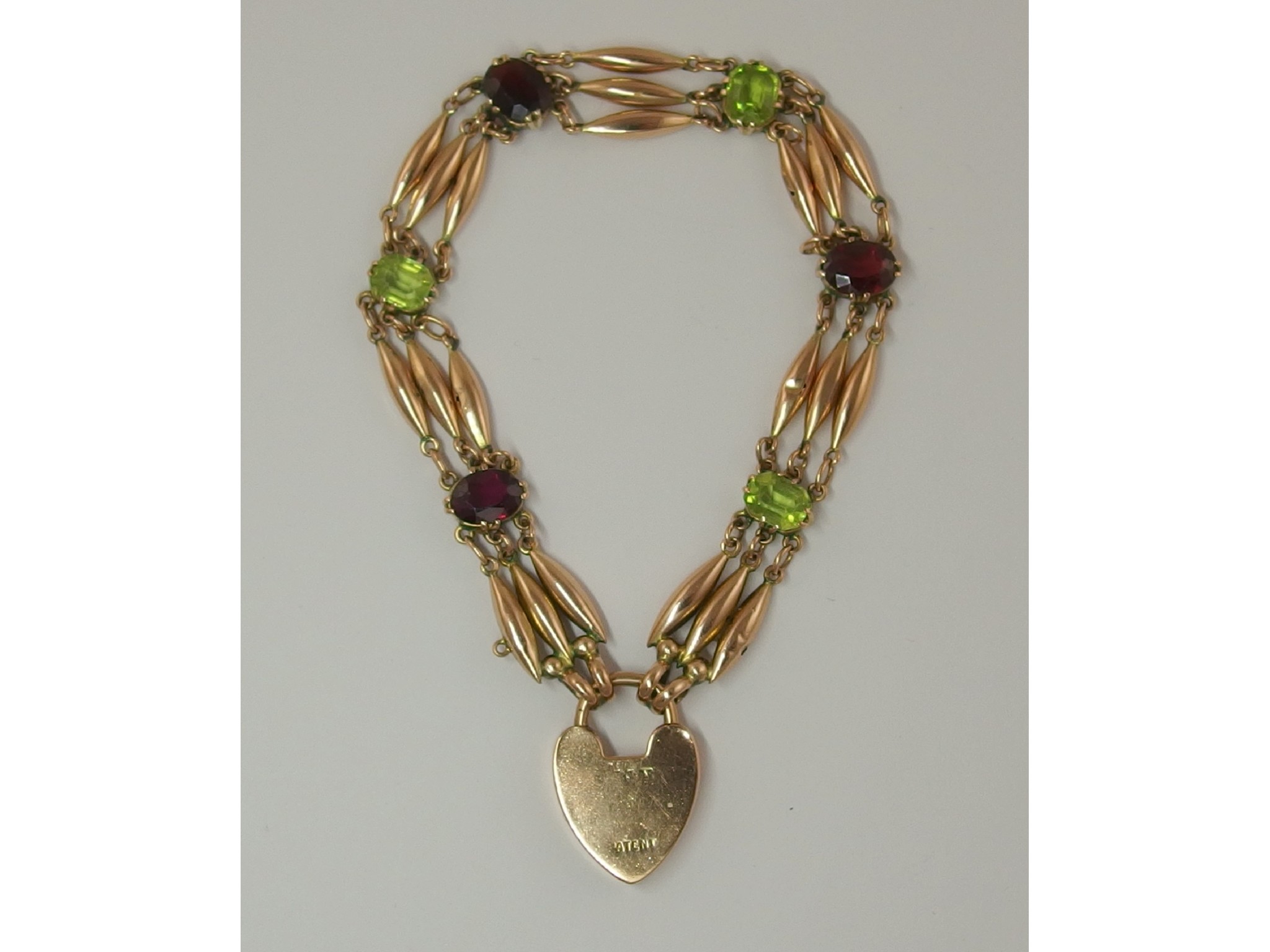 Appraisal: A ct Edwardian garnet and peridot braceletthe three tapered batons