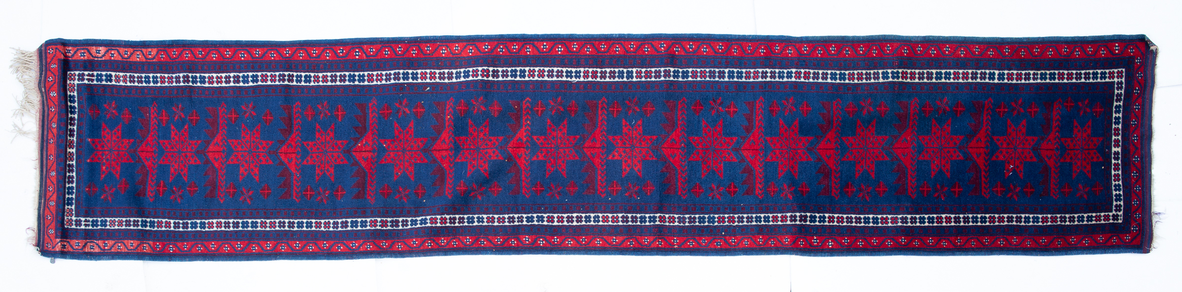 Appraisal: A Turkish blue ground runner with fourteen star motifs to