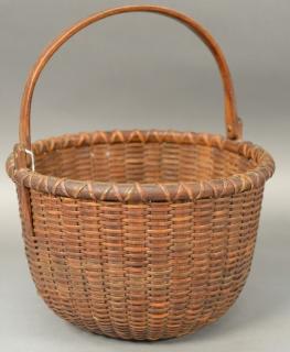 Appraisal: Nantucket basket with swing handle signed on handle L W