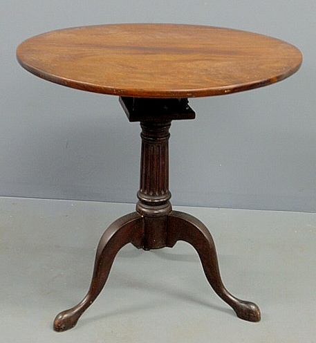 Appraisal: Georgian style mahogany tea table with a birdcage support reeded