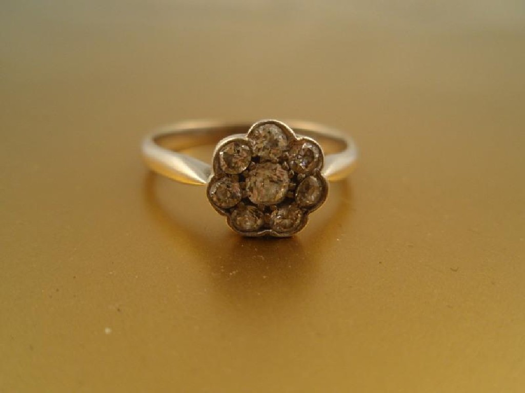 Appraisal: A diamond flower head cluster ring of eight close set