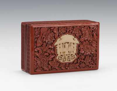 Appraisal: A Carved Cinnabar Box with White Jade Inset Deeply carved