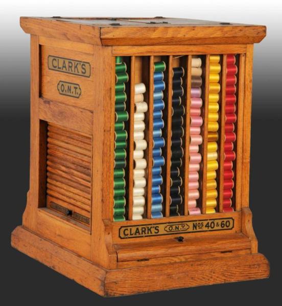 Appraisal: Oak Clark's Revolving Spool Cabinet Description Displays nicely with colorful