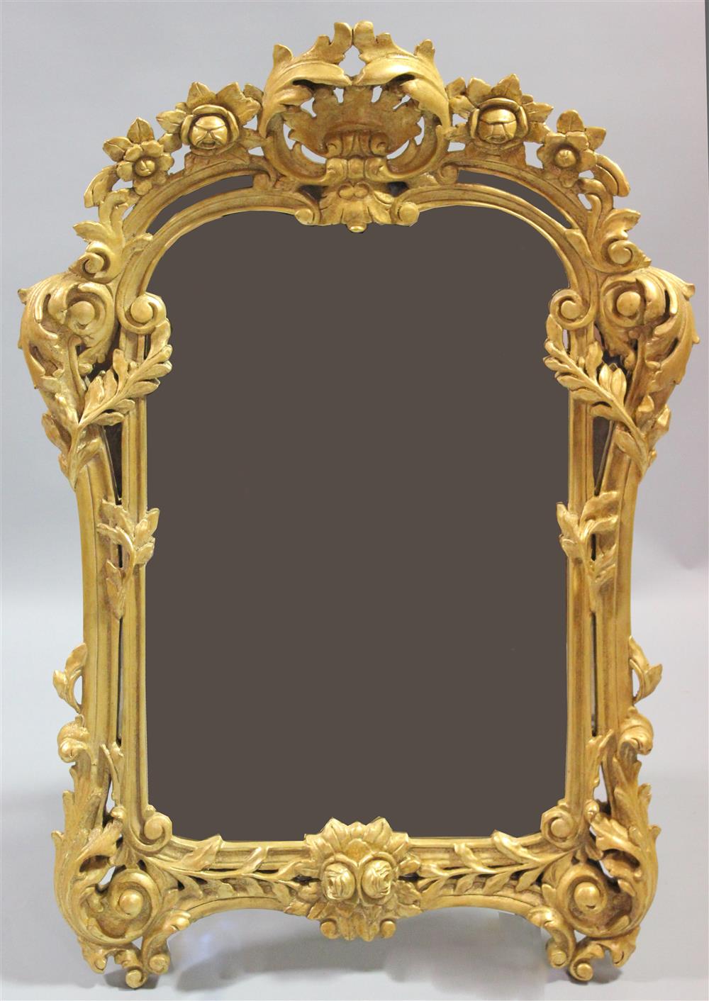 Appraisal: CONTINENTAL CARVED AND PIERCED GILT MIRROR having a heavily carved