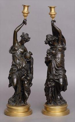 Appraisal: AFTER CARRIER BELLEUSE PAIR OF GILT-BRONZE MOUNTED BRONZE CLASSICAL FIGURES