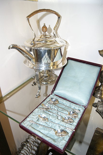 Appraisal: A SILVER PLATED SPIRIT KETTLE on stand of stylised form