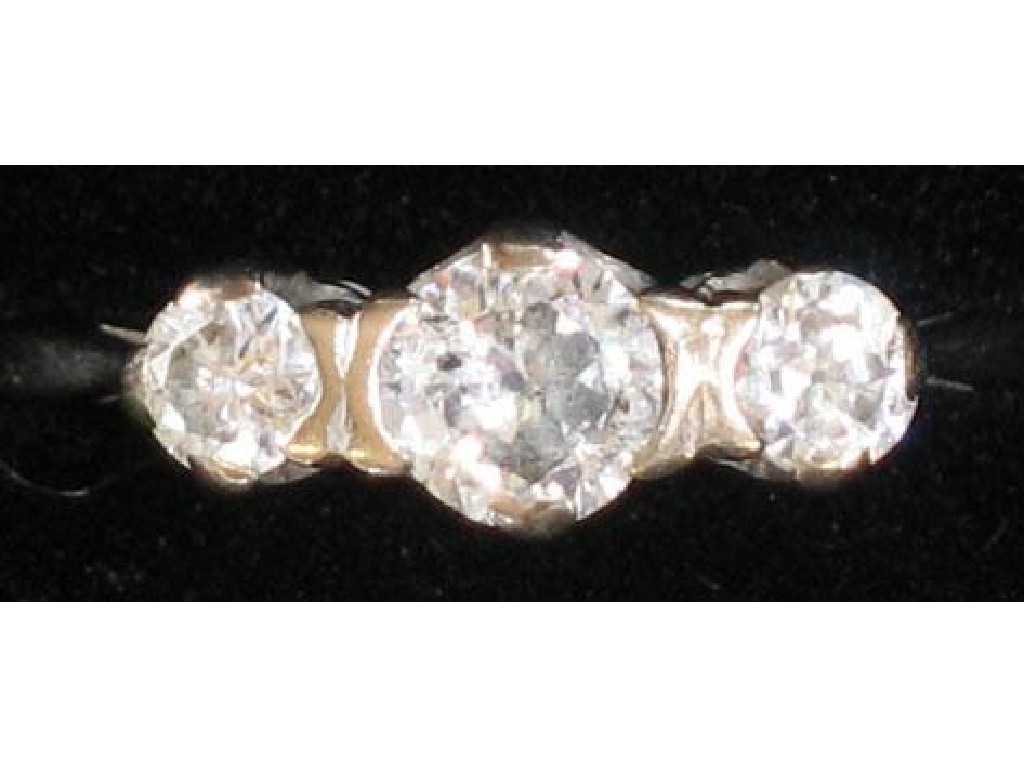 Appraisal: A THREE STONE DIAMOND RING the central round brilliant-cut diamond