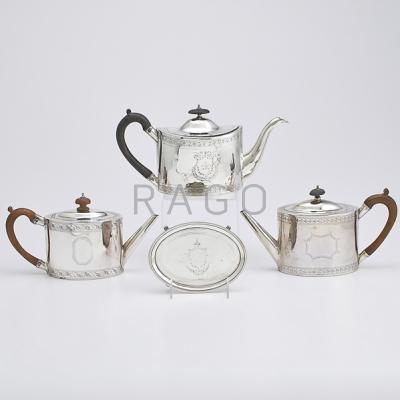 Appraisal: THREE GEORGE III SILVER TEAPOTS AND A STAND Oval teapots