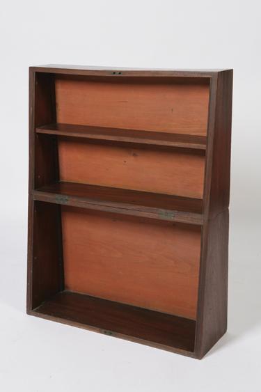 Appraisal: A FOLDING MAHOGANY CAMPAIGN BOOKCASE in two parts with a