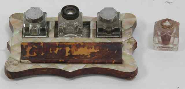 Appraisal: A mother-of-pearl and tortoiseshell desk tidy with three associated inkwells