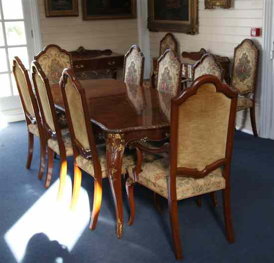 Appraisal: An th century design thirteen piece parcel gilt walnut dining