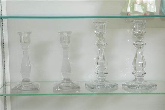 Appraisal: FOUR HEISEY CLEAR GLASS CANDLESTICKS Consisting of two pairs Each