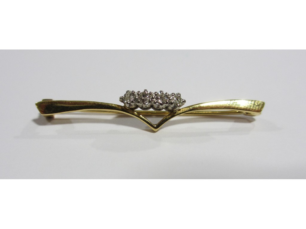 Appraisal: Eighteen carat gold and platinum diamond set wishbone bar brooch