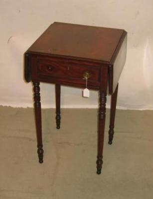 Appraisal: A MAHOGANY WORK TABLE of rounded oblong form with two